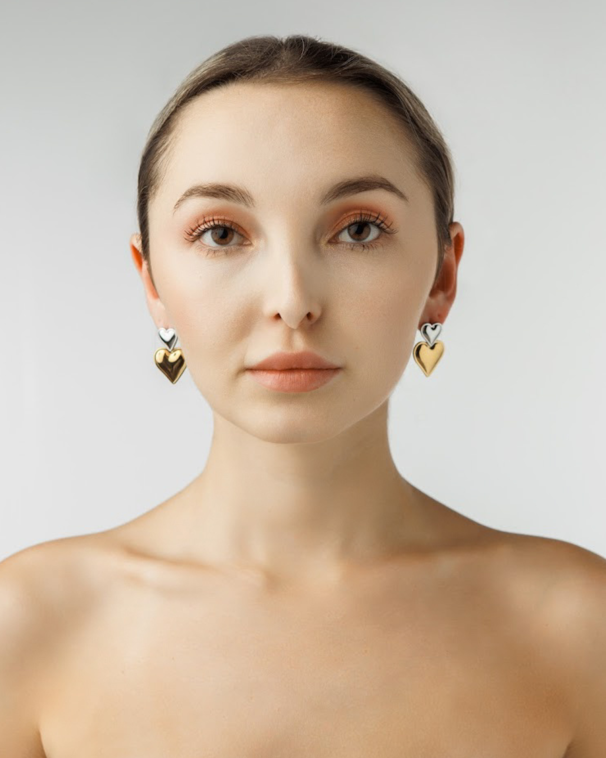 Elegant look with Giselle Earrings featuring gold and silver hearts.