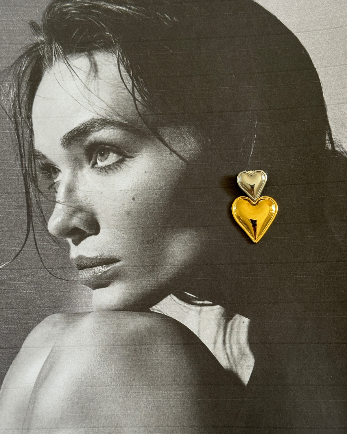 Side profile of model wearing Giselle Earrings showcasing heart-shaped design.