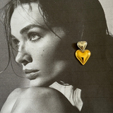 Side profile of model wearing Giselle Earrings showcasing heart-shaped design.