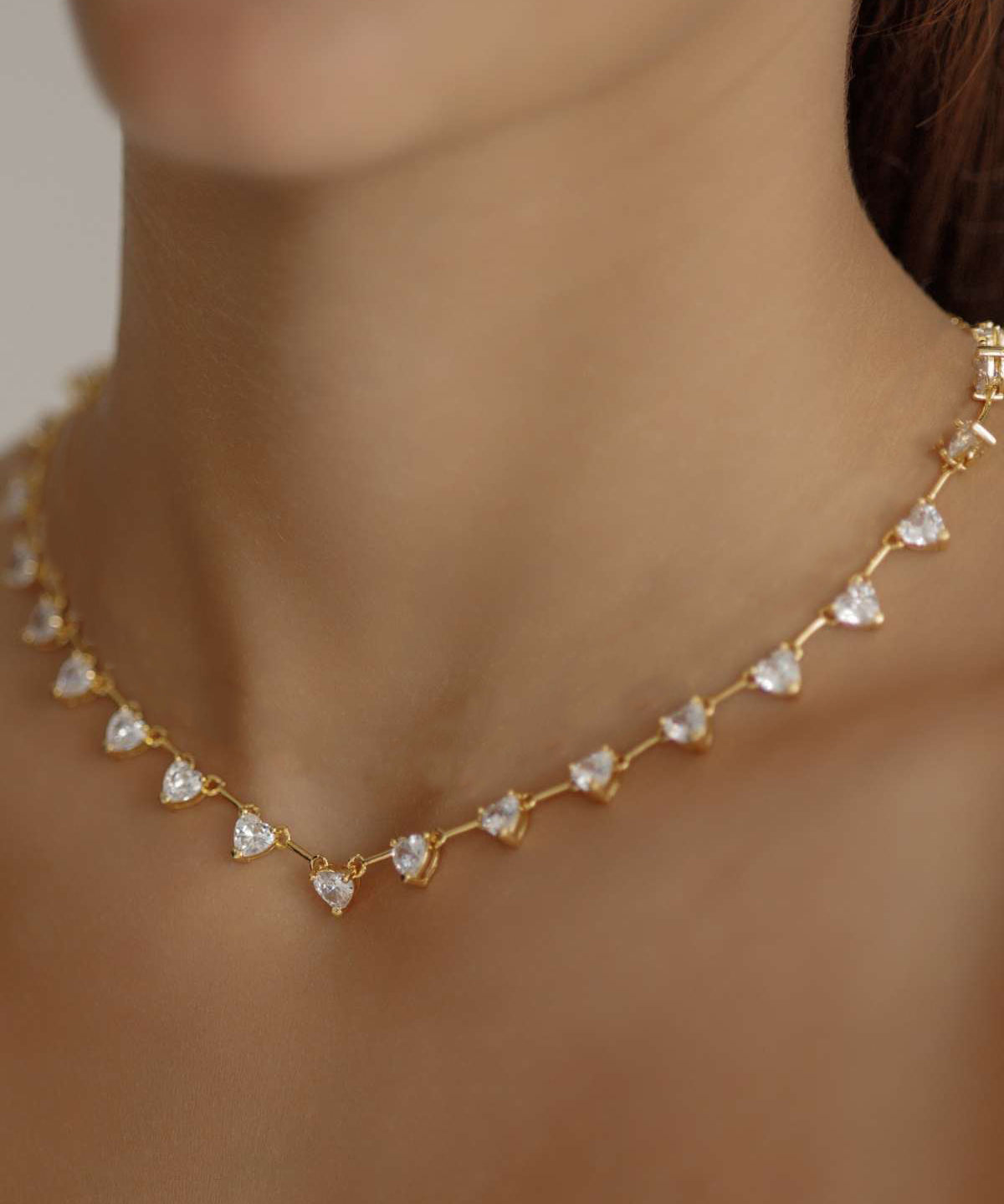 Closeup of the Heart Necklace worn, highlighting the sparkling heart stones.
