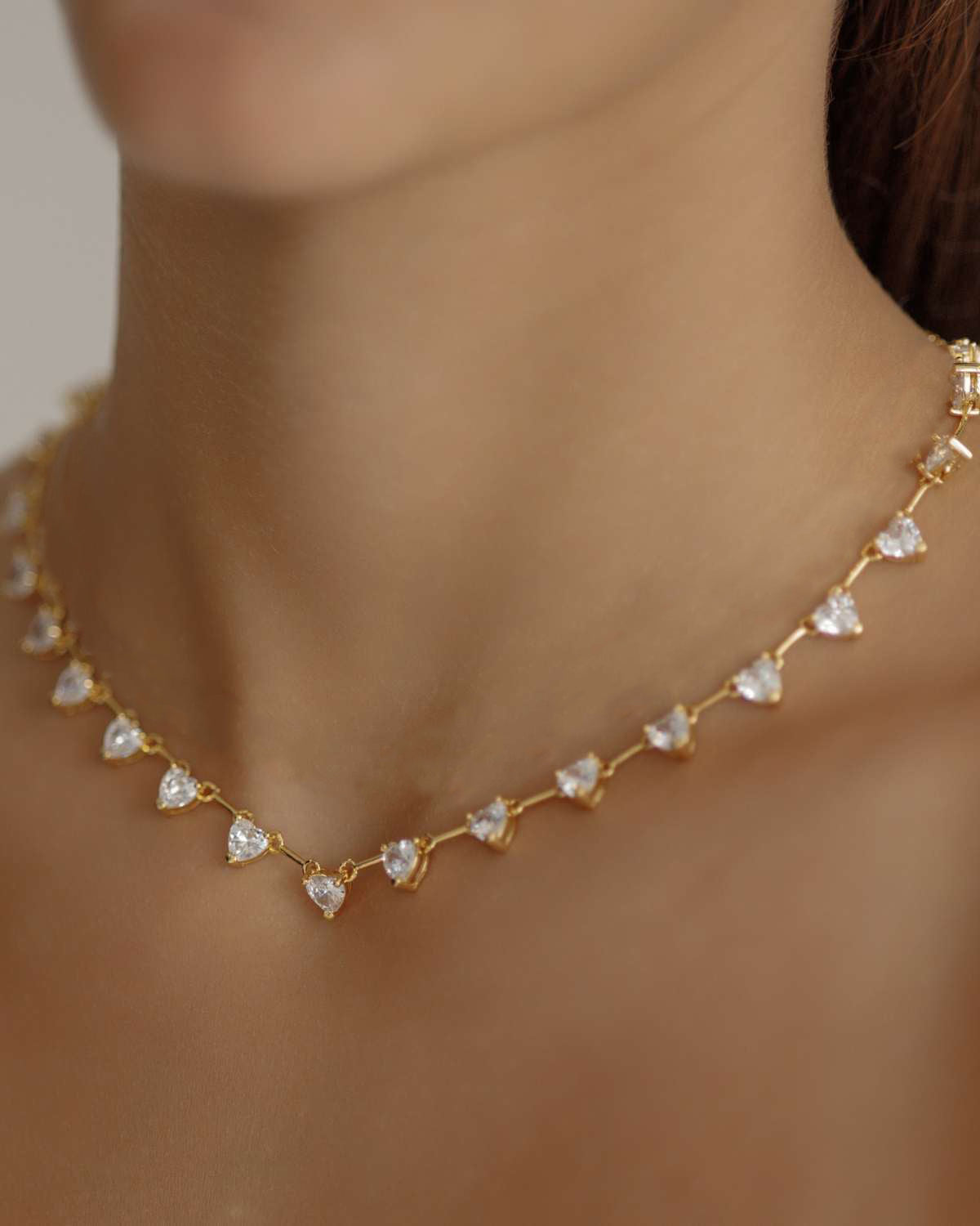 Closeup of the Heart Necklace worn, highlighting the sparkling heart stones.