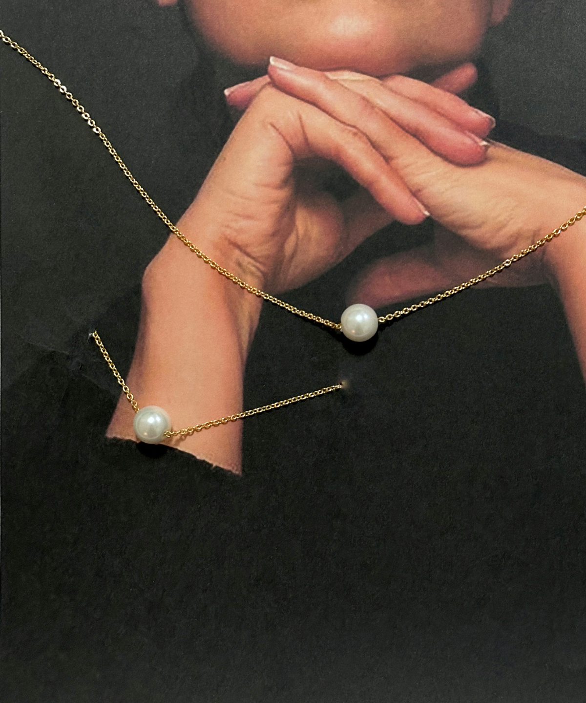 Closeup of model wearing Ina Bracelet with pearl on gold chain.