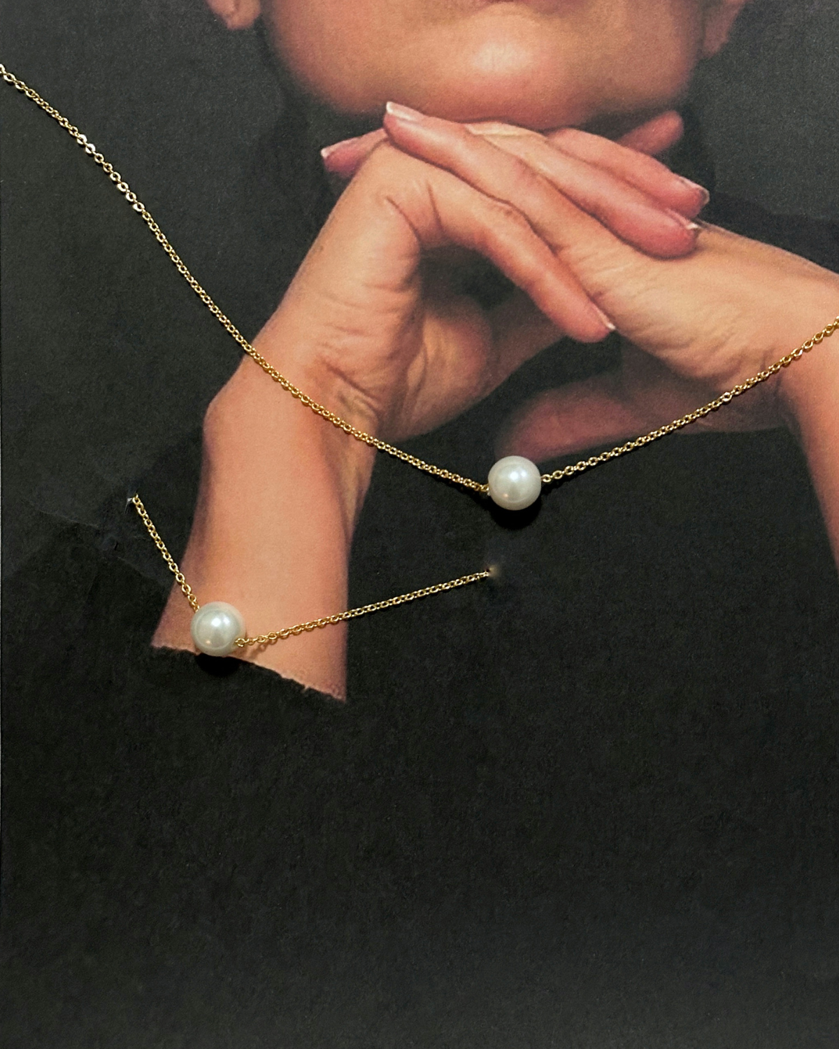 Closeup of model wearing Ina Bracelet with pearl on gold chain.