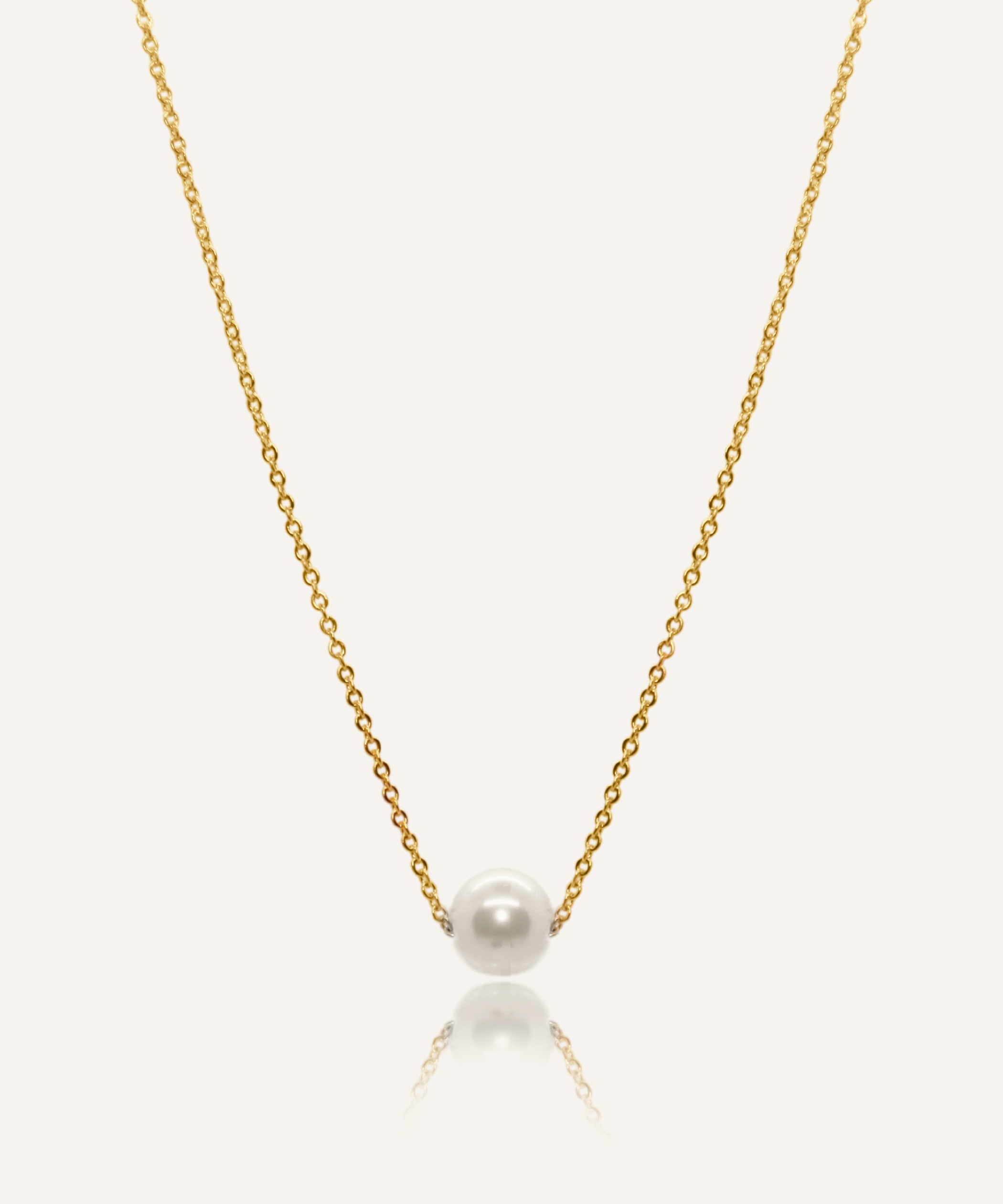 Ina Necklace featuring a gold chain with a single pearl pendant.