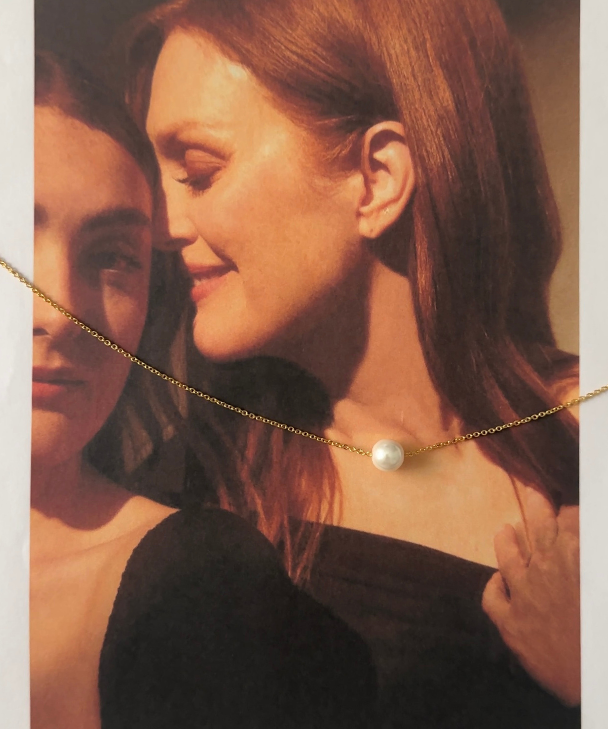 Ina Necklace worn alone on model’s neck with delicate gold chain and pearl.