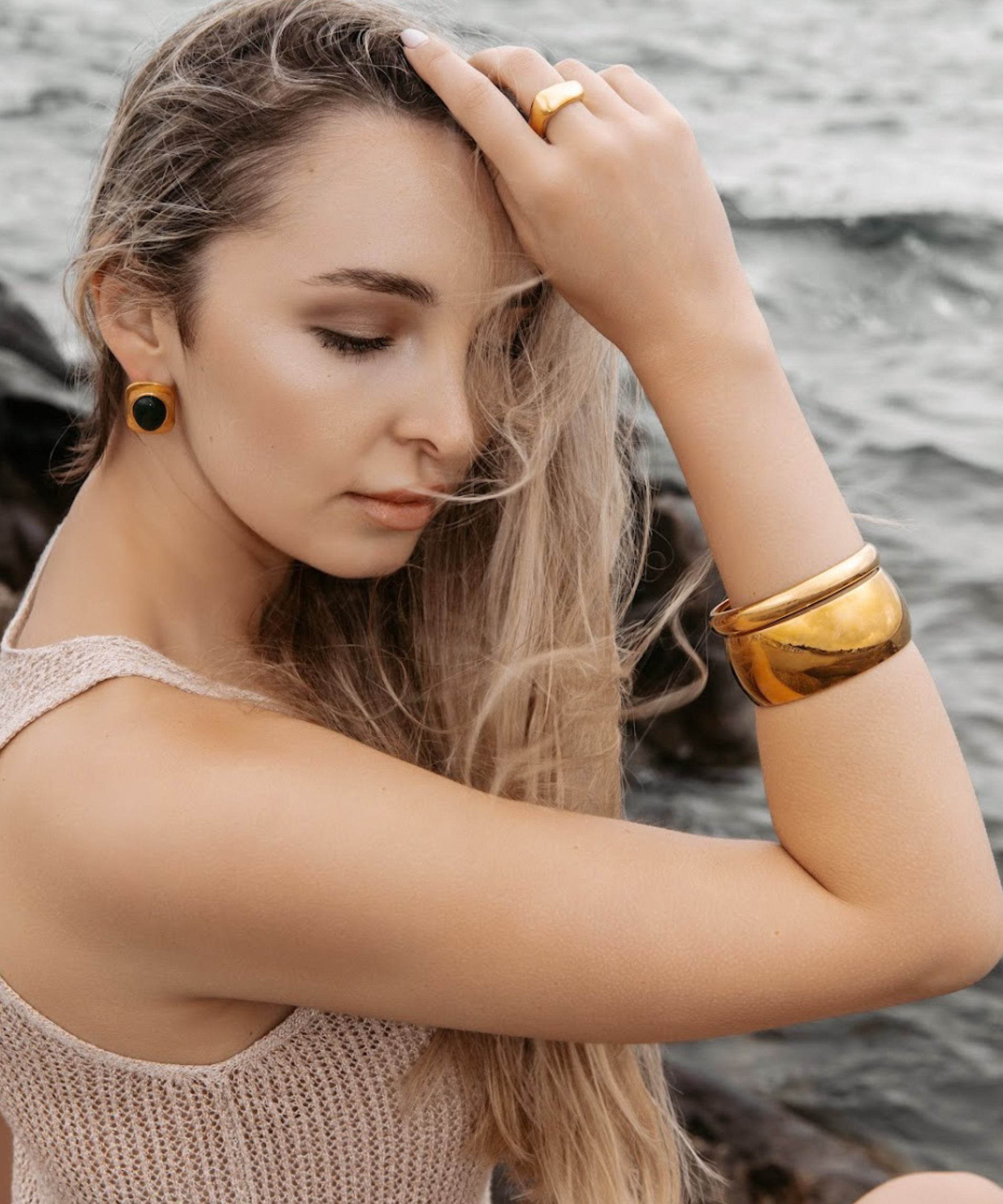Woman wearing the Indie Gold Cuff with a light brown top, showcasing its bold yet minimal design.