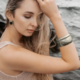 Woman wearing the Indie Silver Cuff with a white blouse, showcasing its minimalist elegance.