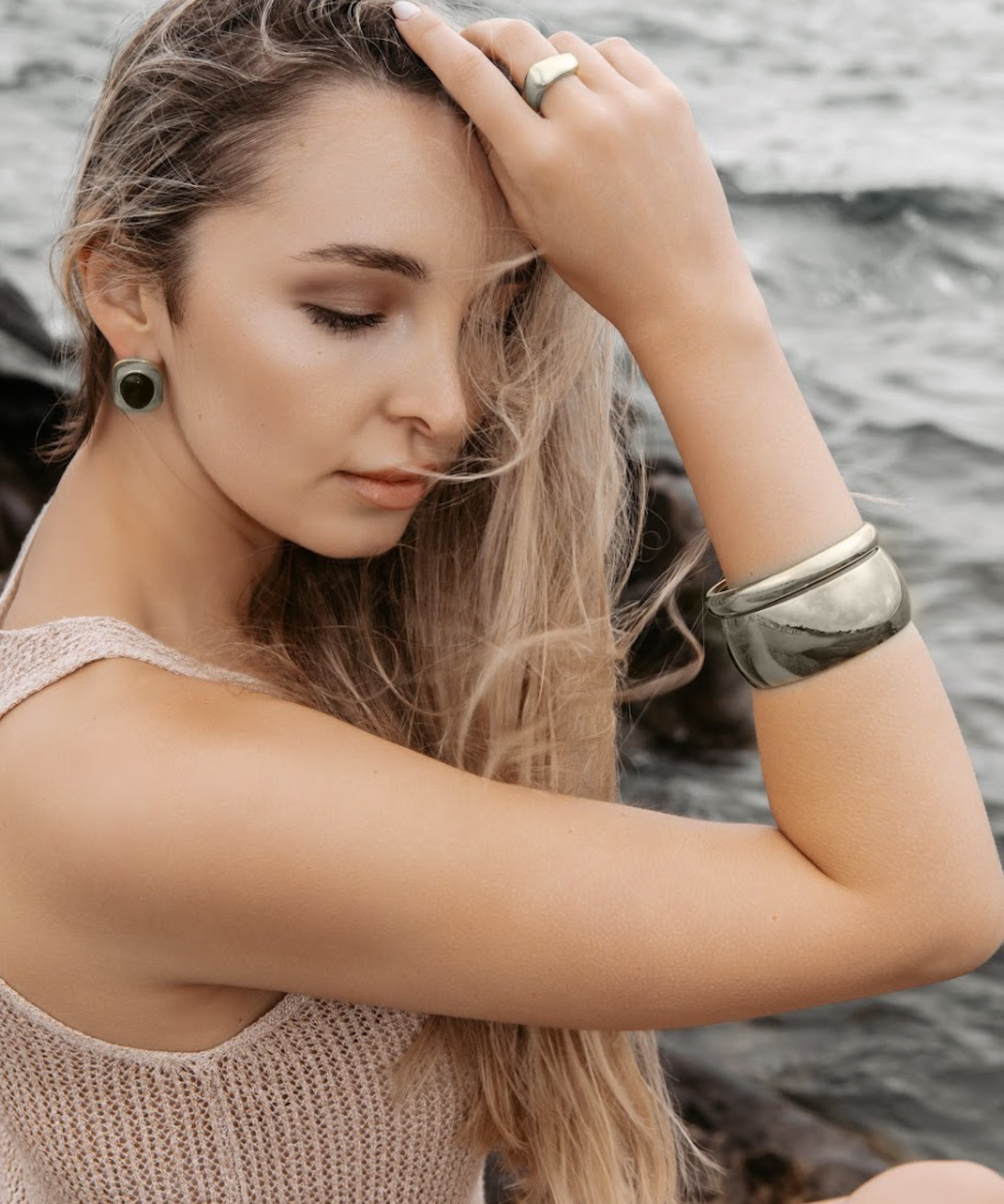 Woman wearing the Indie Silver Cuff with a white blouse, showcasing its minimalist elegance.