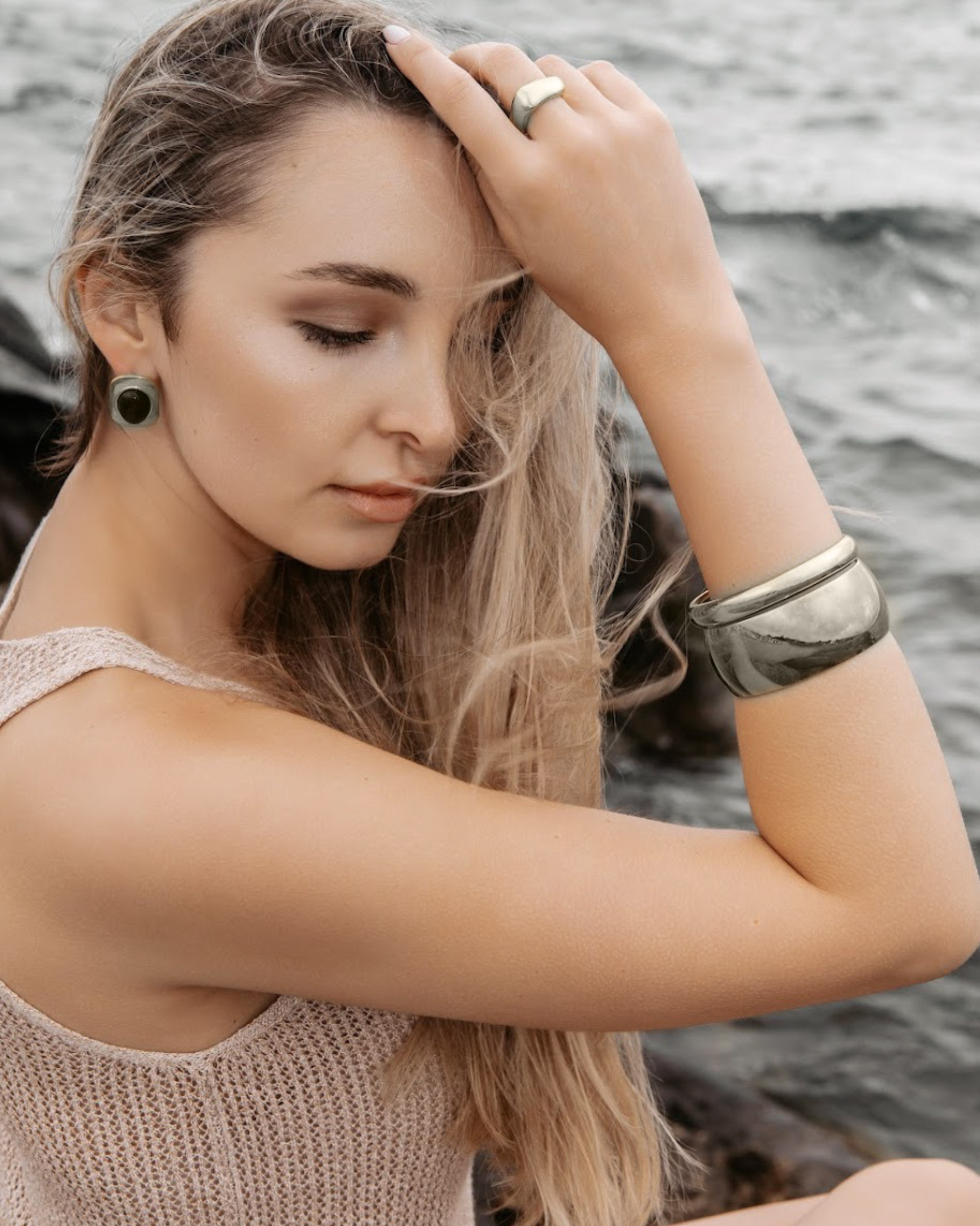 Woman wearing the Indie Silver Cuff with a white blouse, showcasing its minimalist elegance.