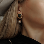 Close-up of Ivy Earrings worn, showcasing green quartz and pearl details.