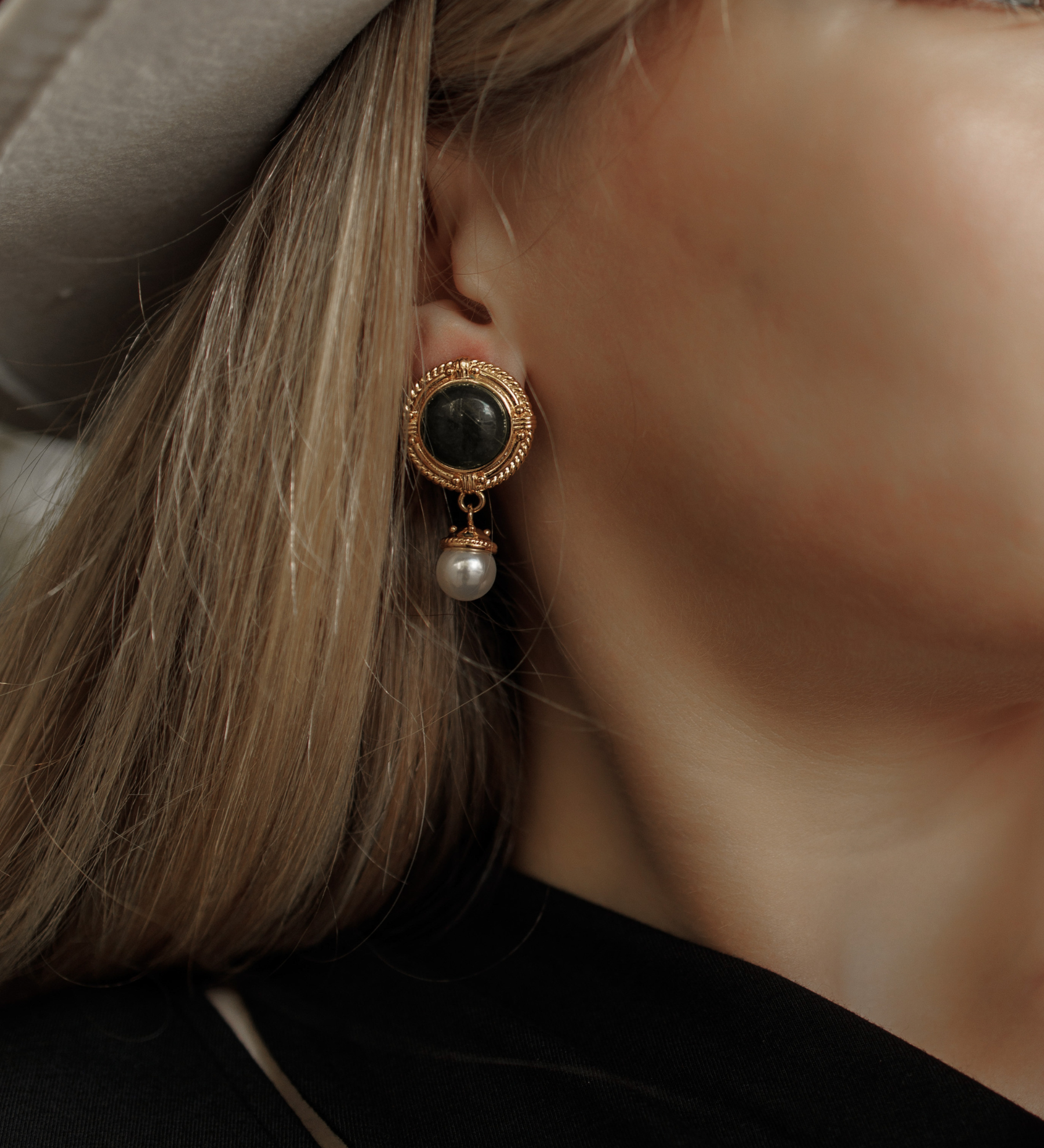Close-up of Ivy Earrings worn, showcasing green quartz and pearl details.