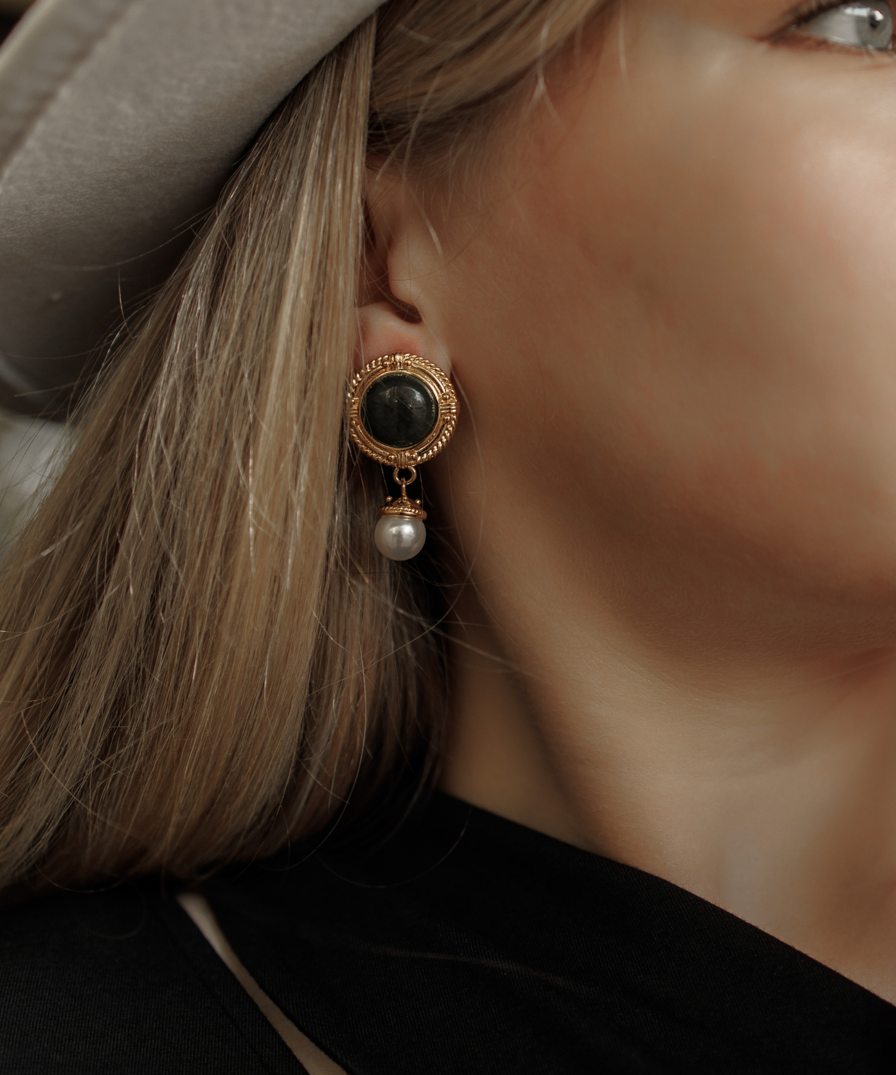Close-up of Ivy Earrings worn, showcasing green quartz and pearl details.
