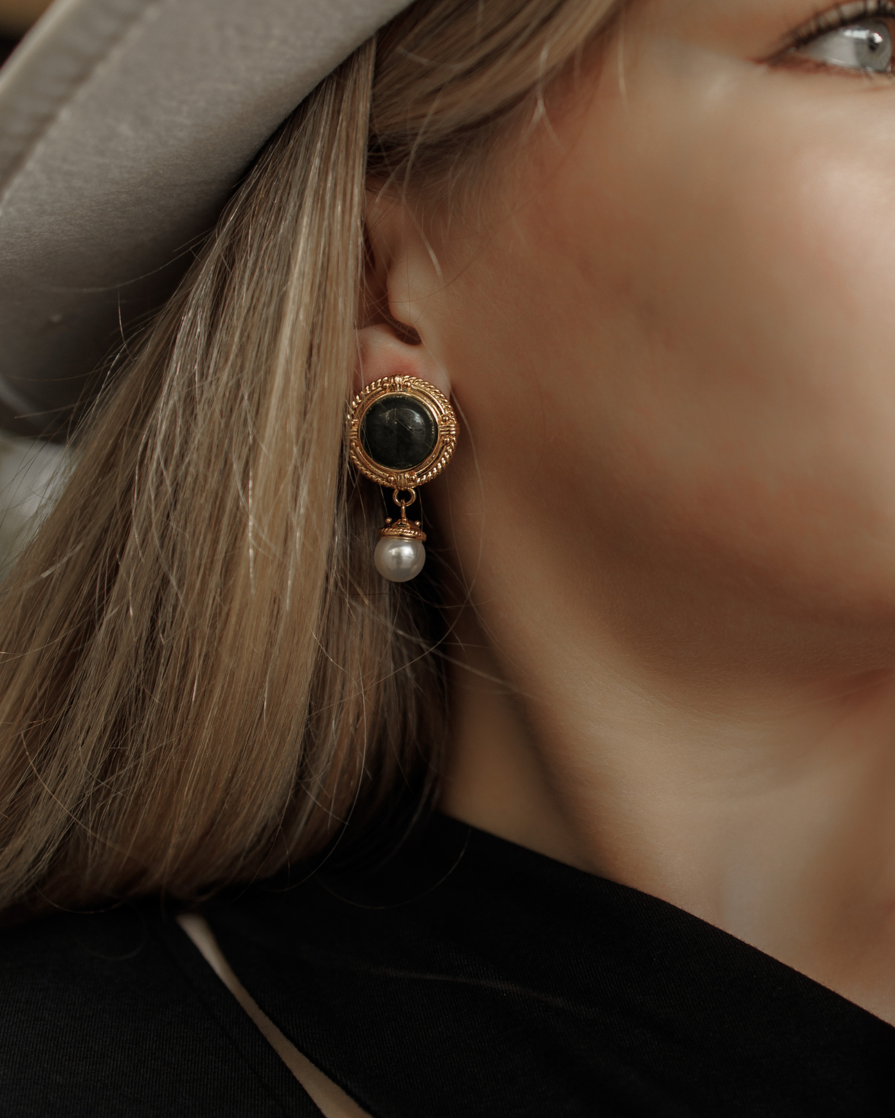 Close-up of Ivy Earrings worn, showcasing green quartz and pearl details.