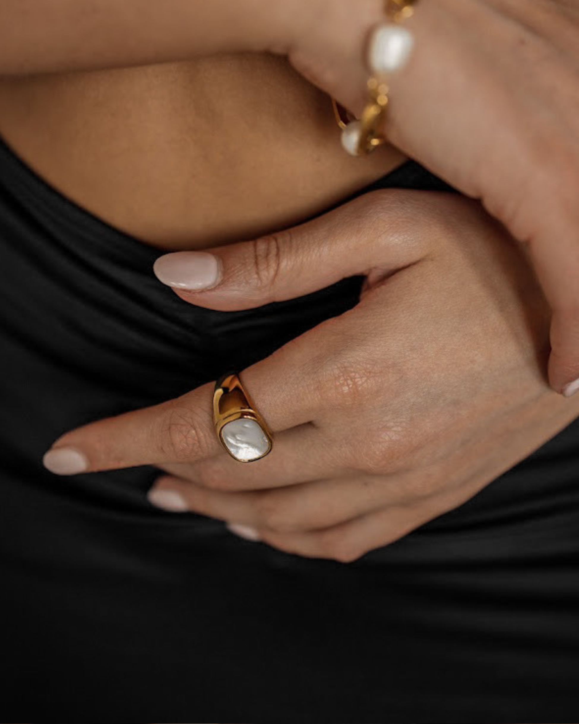 Closeup of model wearing Kai Ring, highlighting cowry shell detail.