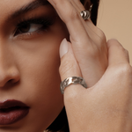 Side view of model wearing the silver Kalani Ring, showing its thickness and polished look.