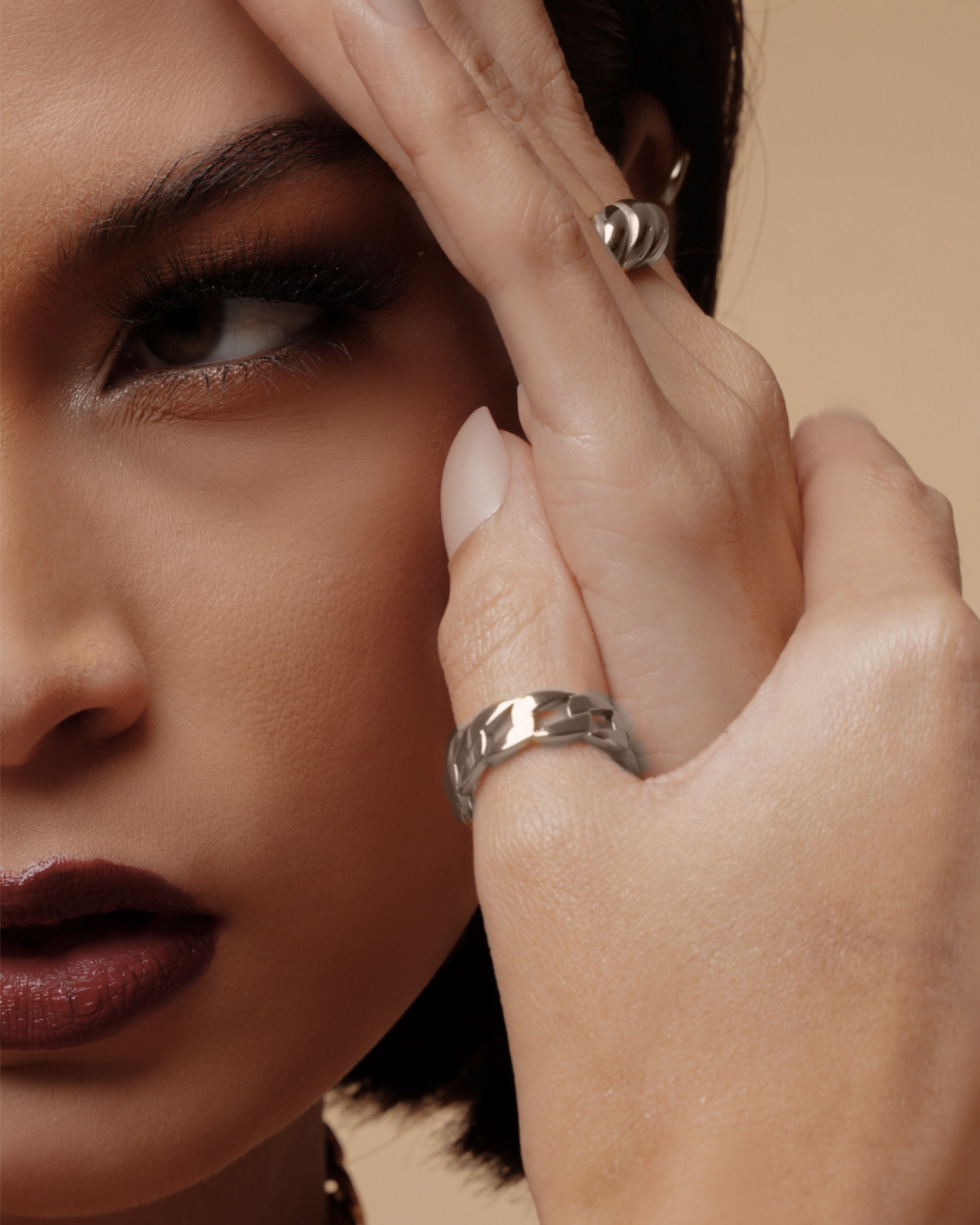 Side view of model wearing the silver Kalani Ring, showing its thickness and polished look.