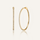 Lana gold hoop earrings with zirconia stones in a sleek, minimalist design.