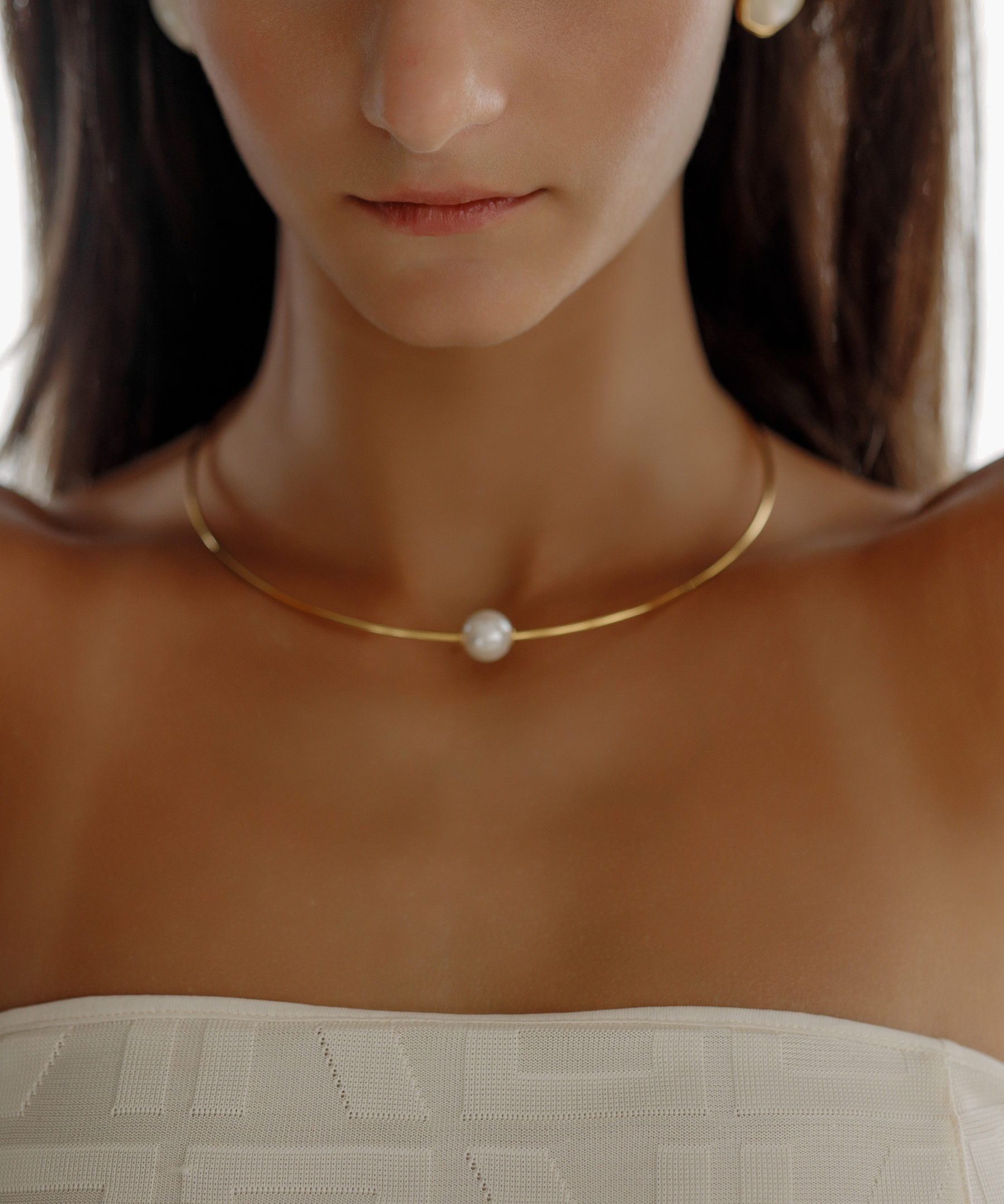 Close-up of Loreli Choker worn on neck, highlighting the pearl centerpiece.