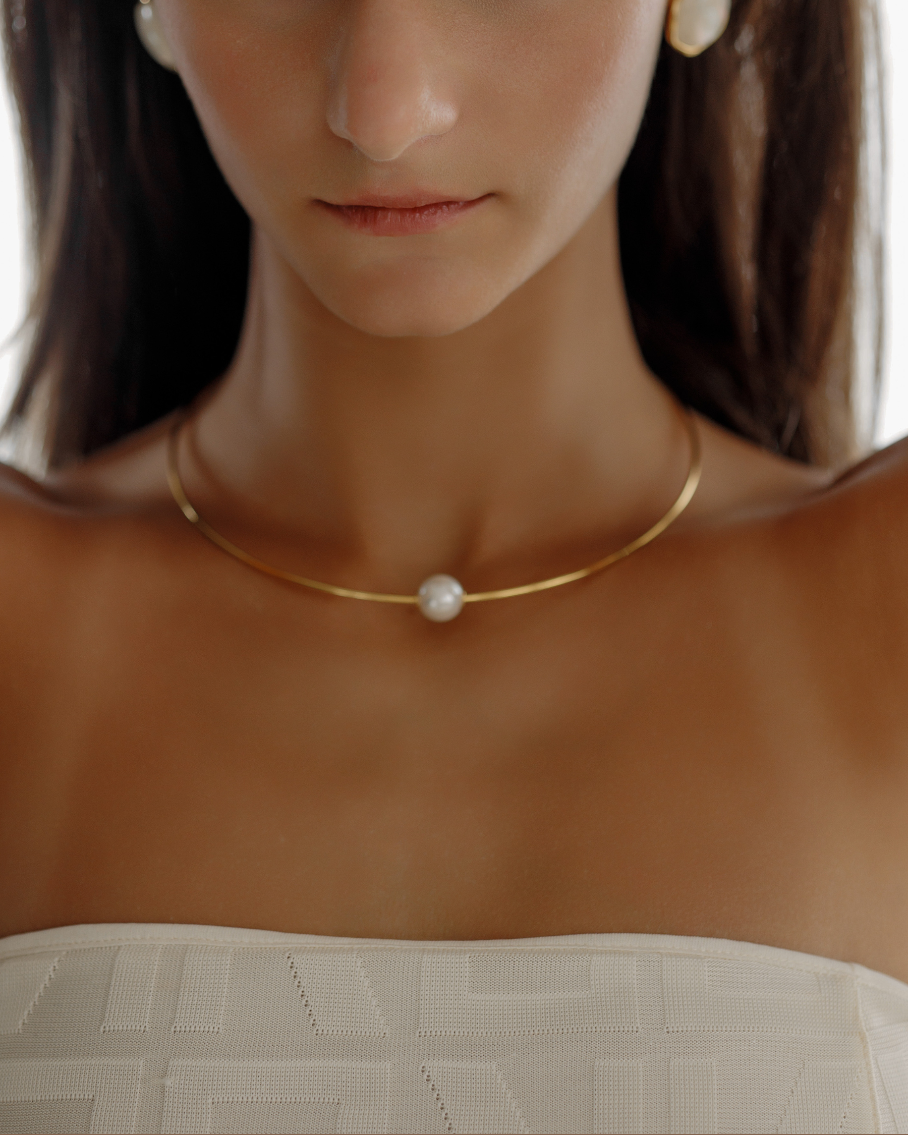 Close-up of Loreli Choker worn on neck, highlighting the pearl centerpiece.