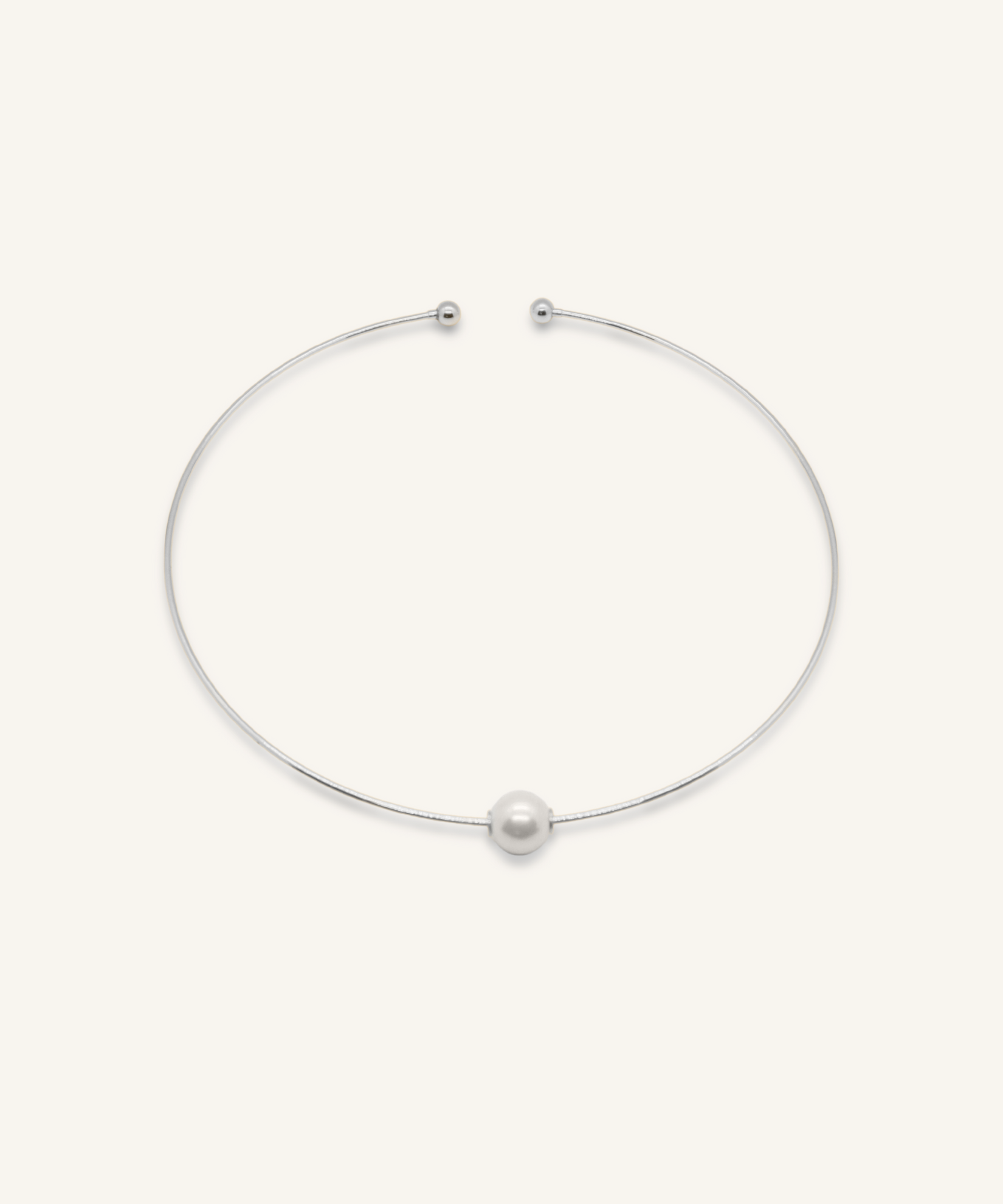Silver-coated Loreli Choker with central pearl and paperclip chain design, laid flat to highlight details.