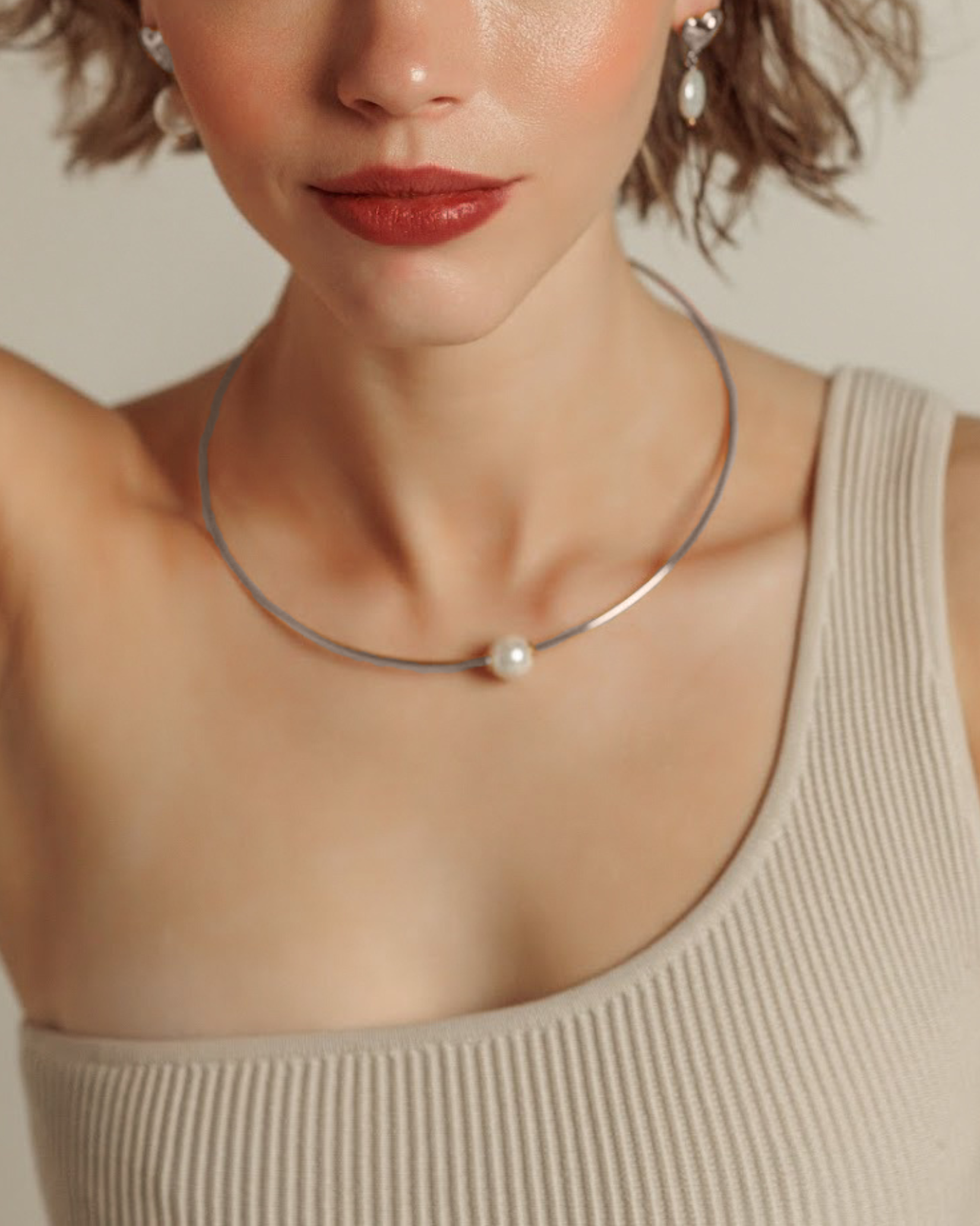 Model wearing the Loreli Choker in silver with a pearl centerpiece, showcasing its elegant, minimal style.