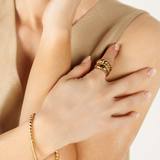 Love Bracelet styled with a brown sleeveless top, showing its versatility as a daily statement piece.