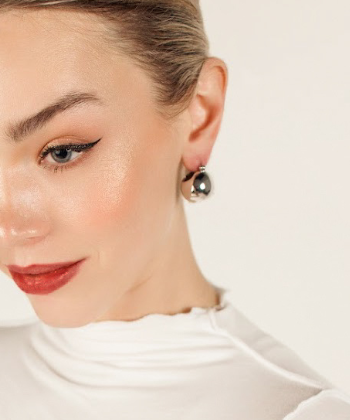 Close-up of Maeve Earrings in silver highlighting the shiny, bold dome form.