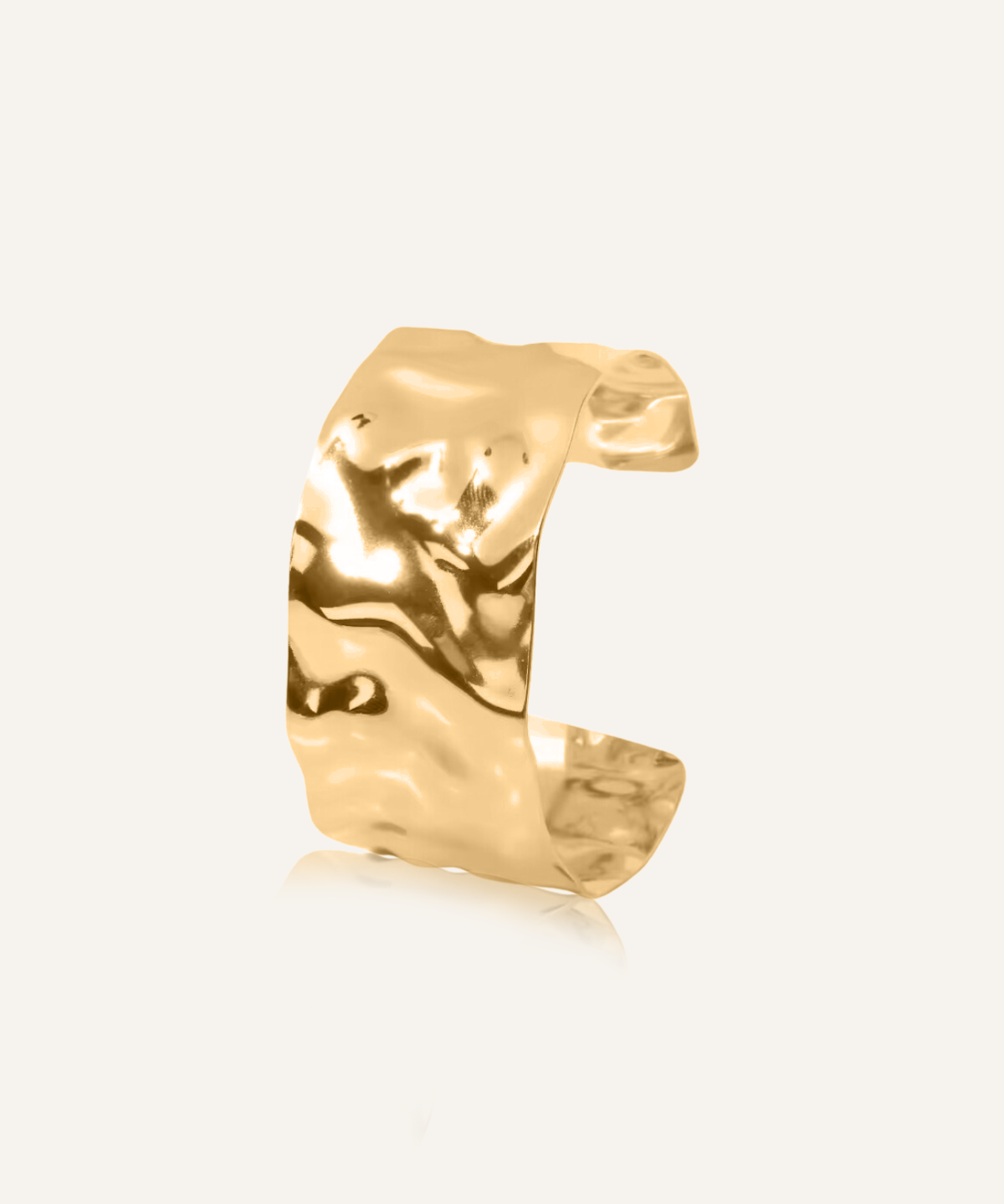 Mara Cuff in gold with sculptural molten texture shown in flatlay.