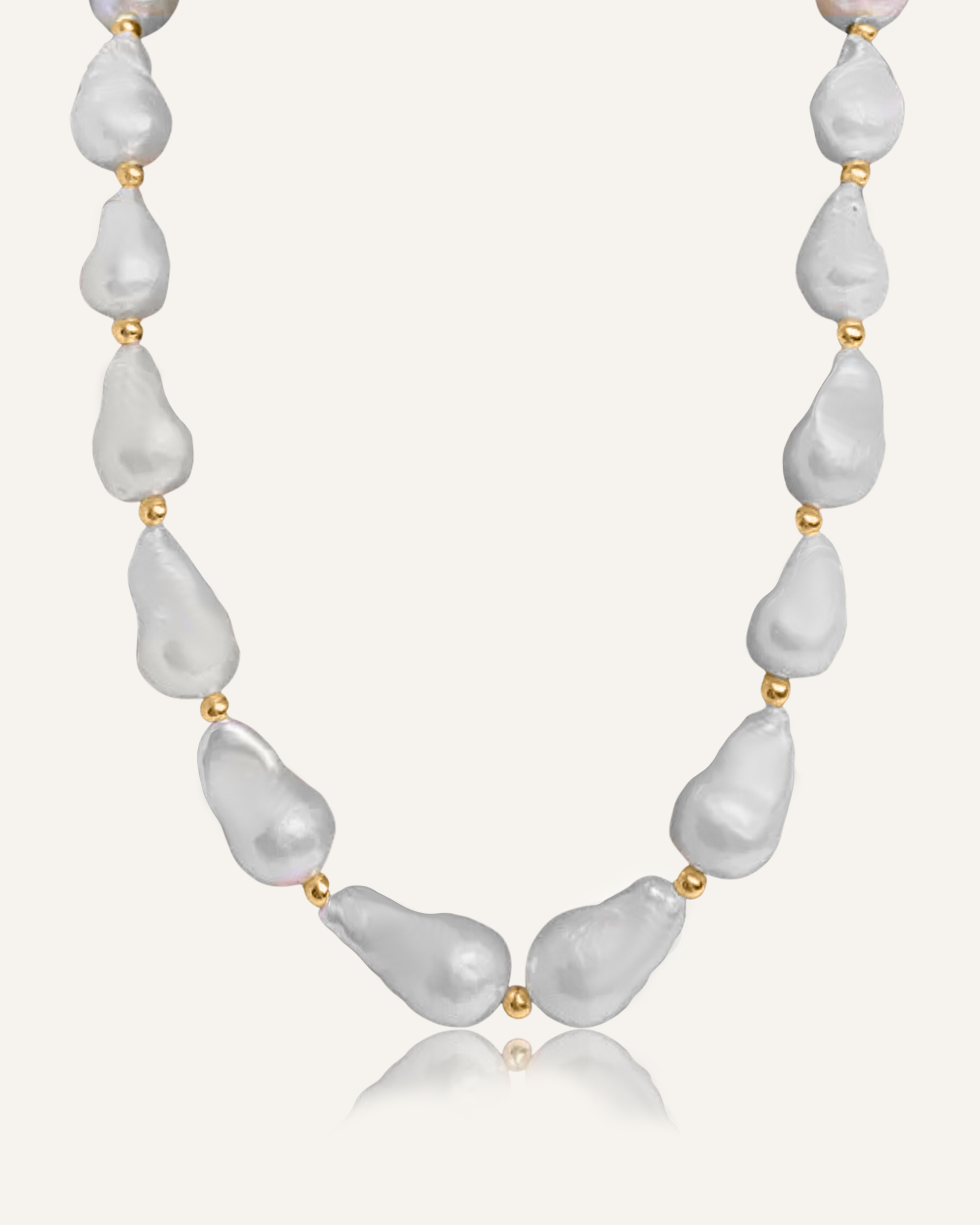 Product flatlay of the Margaret Necklace showcasing baroque pearls and gold bead accents.