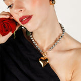 Close-up of the Margaux Necklace gold heart pendant and toggle clasp detail.