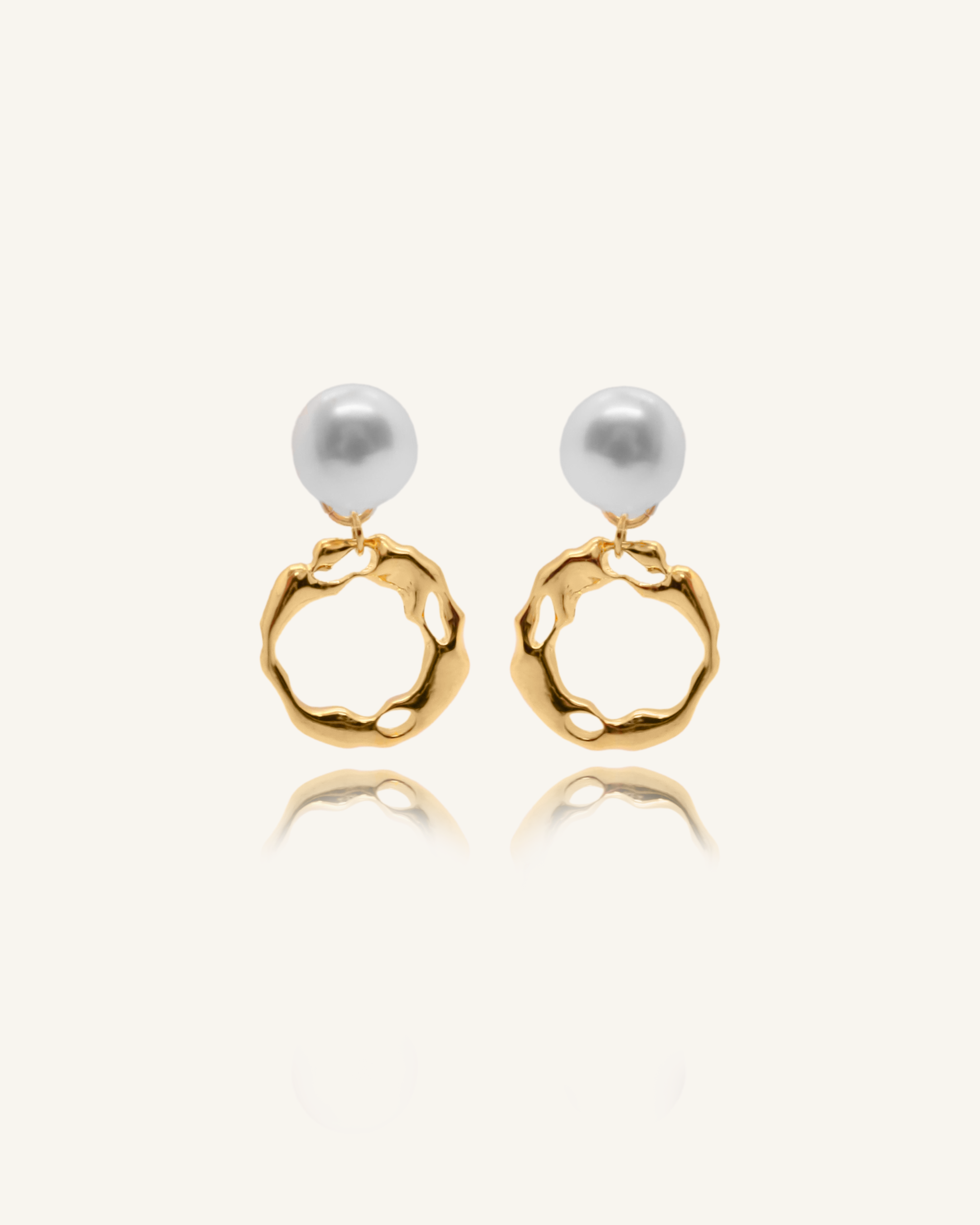 Maria Earrings featuring gold irregular hoops and freshwater pearl drops.