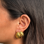 Close-up of model wearing Mini Demi Earrings, showing golden croissant hoop details.