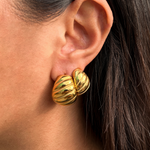 Model styling the Mini Demi Earrings for a chic Parisian look.