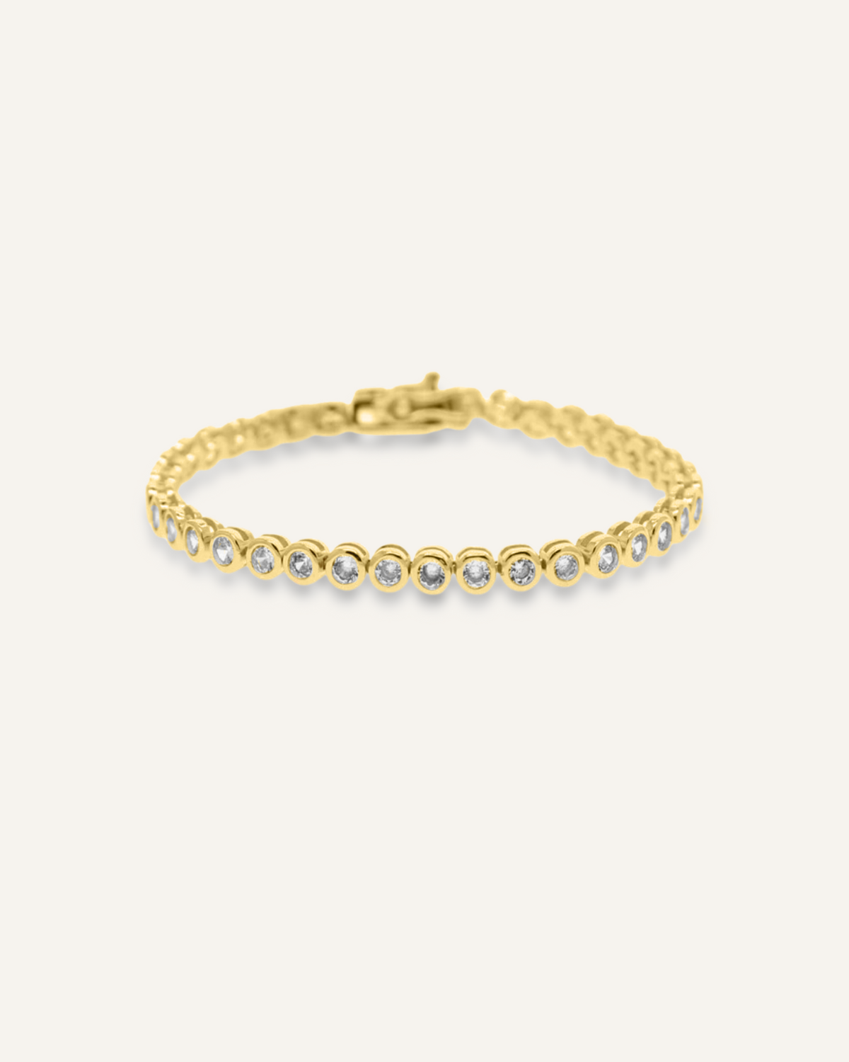 Flatlay of Mira Bracelet featuring gold tennis chain and sparkling zirconia stones.
