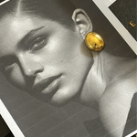 Mona Gold Earrings worn by model, highlighting bold drop shape and size.