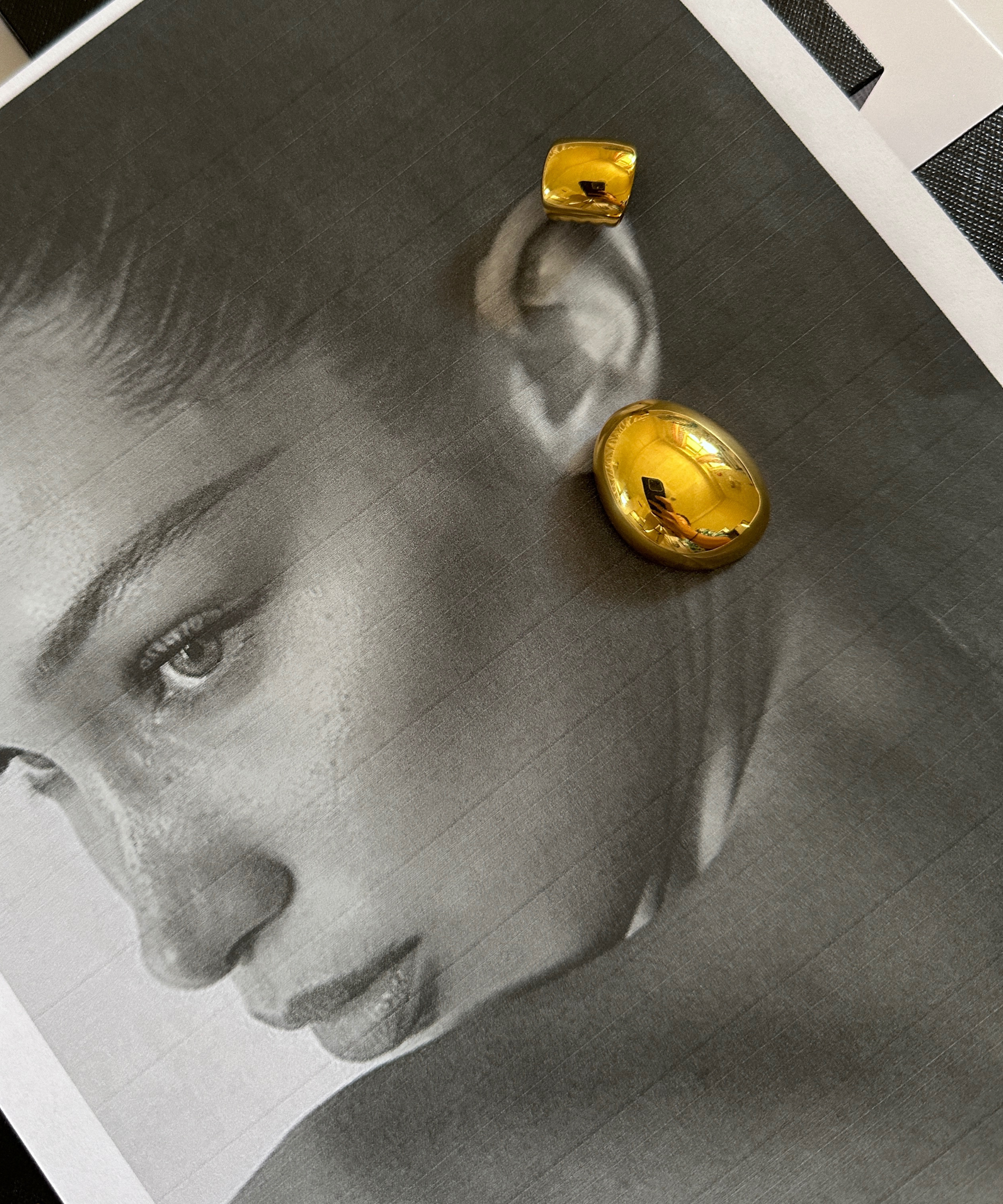 Model wearing Mona Gold Earrings showing off their artistic dome shape.