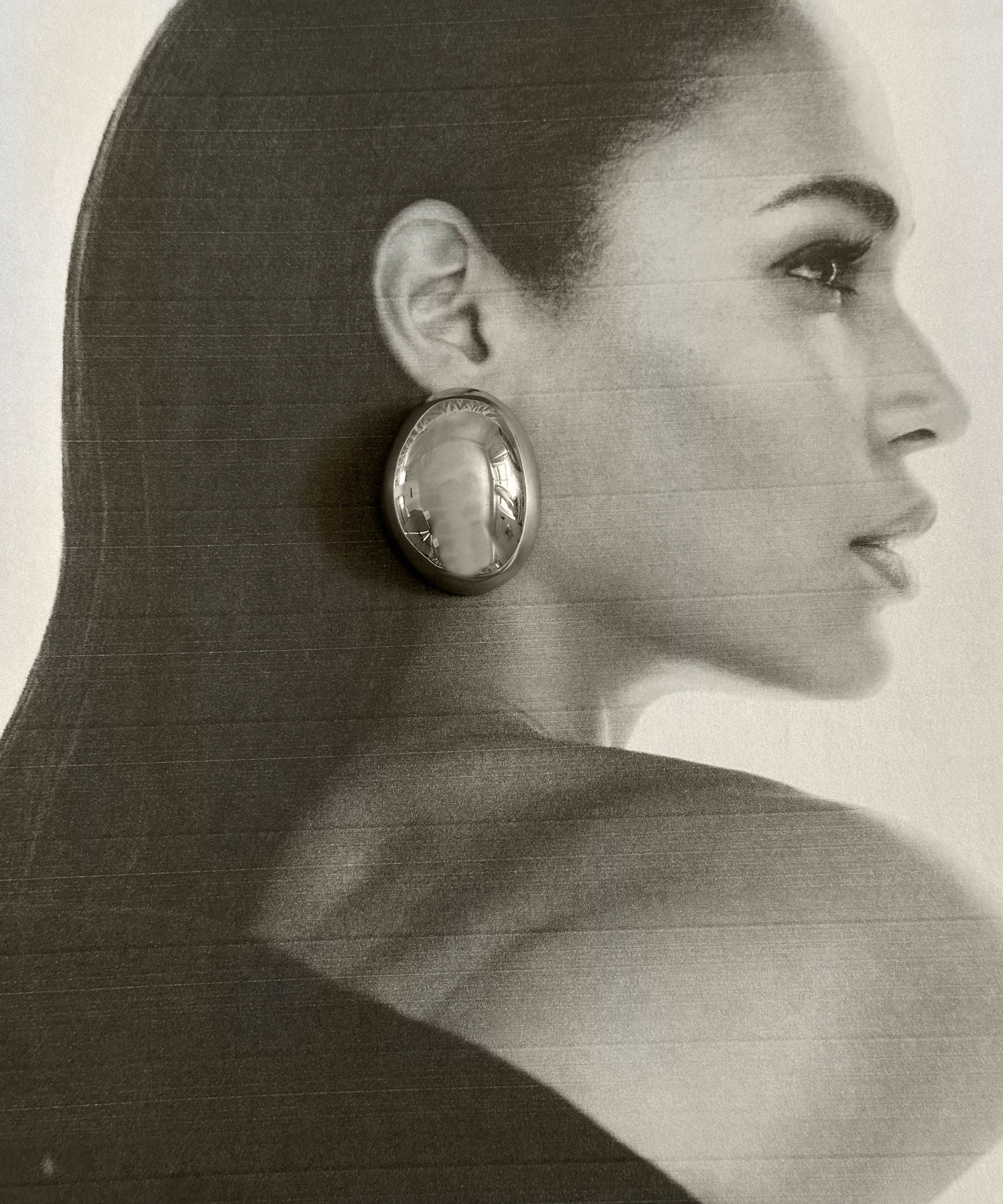 Model wearing Mona Silver Earrings showcasing their oval dome silhouette.