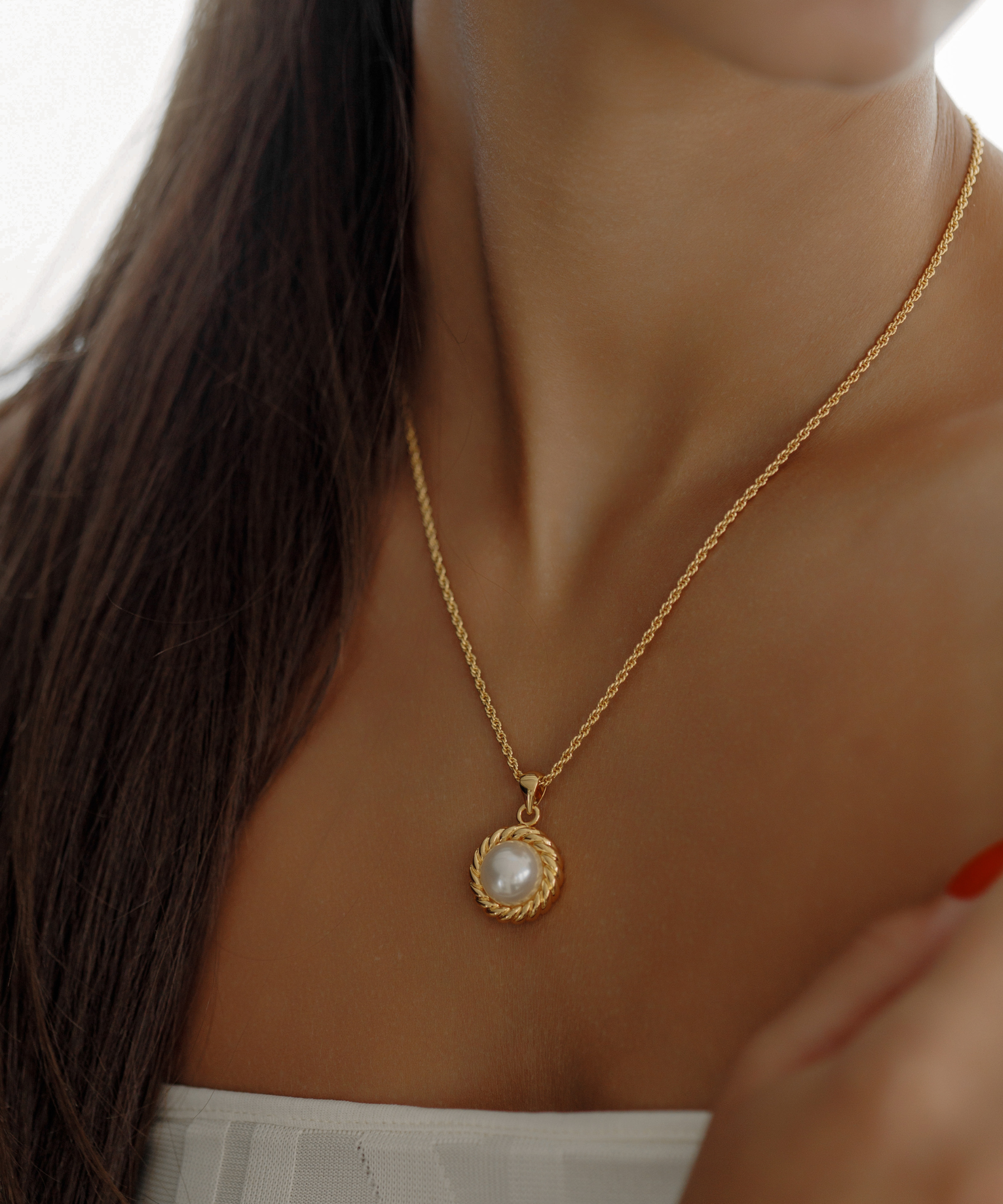 Close-up of the Myrcella Necklace worn on neck, highlighting pearl pendant detail.