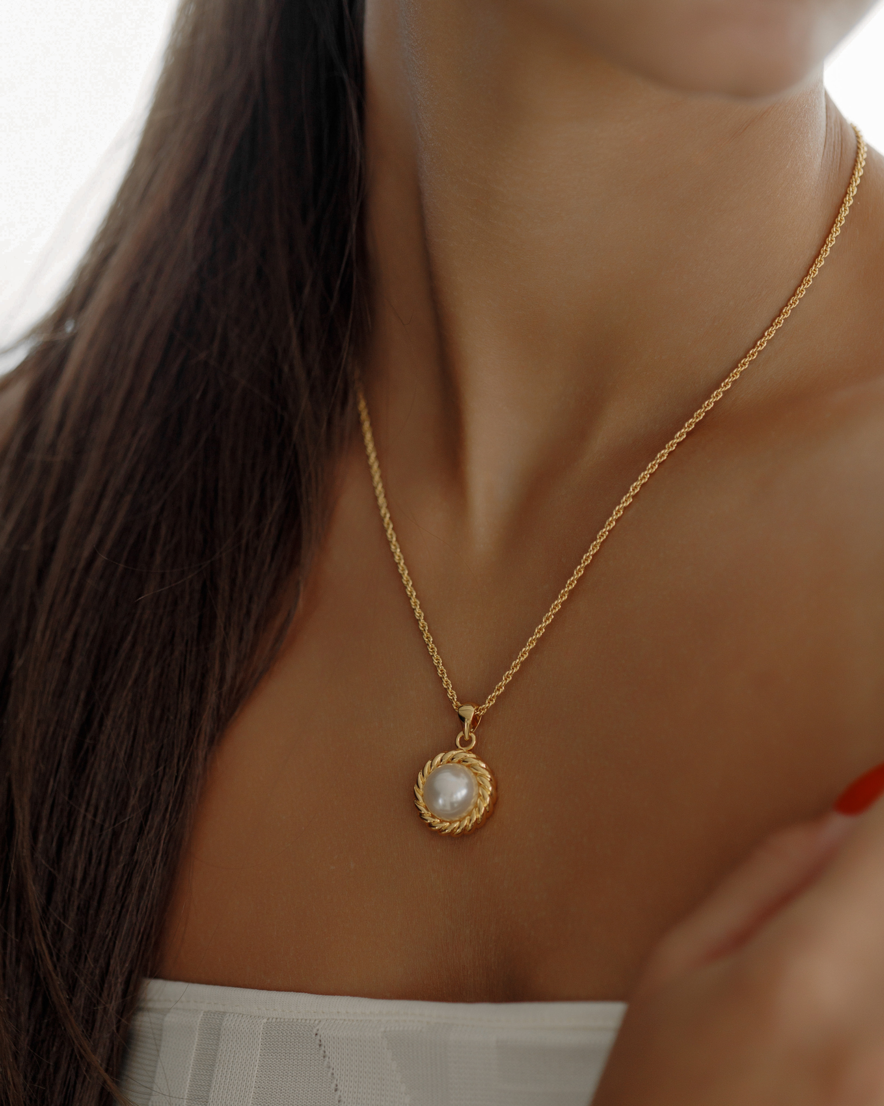 Close-up of the Myrcella Necklace worn on neck, highlighting pearl pendant detail.