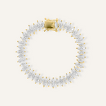 Flatlay of Naomi Bracelet in gold with horse eye zirconia stones and tennis chain.