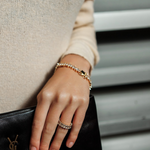 Model wearing the Naomi Bracelet in gold, showcasing the elegant zirconia sparkle.