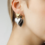 Close-up of Sadie Earrings showing gold heart atop silver heart detail.