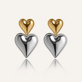 Sadie Earrings with stacked heart design in gold and silver on white background.