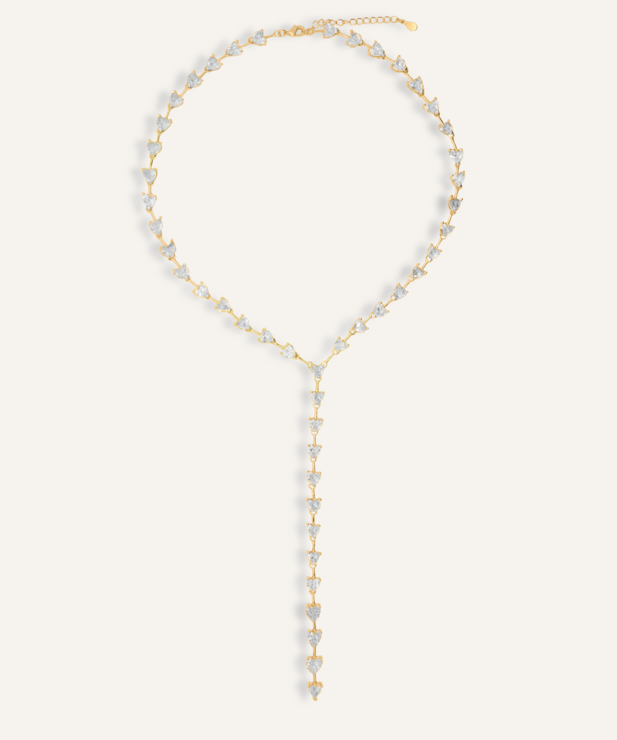 Flatlay of Seraphine Necklace in gold with heart-shaped zirconia charm and Y-drop design.