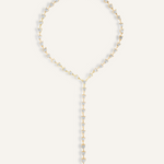 Flatlay of Seraphine Necklace in gold with heart-shaped zirconia charm and Y-drop design.