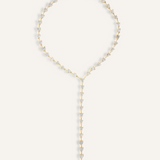 Flatlay of Seraphine Necklace in gold with heart-shaped zirconia charm and Y-drop design.