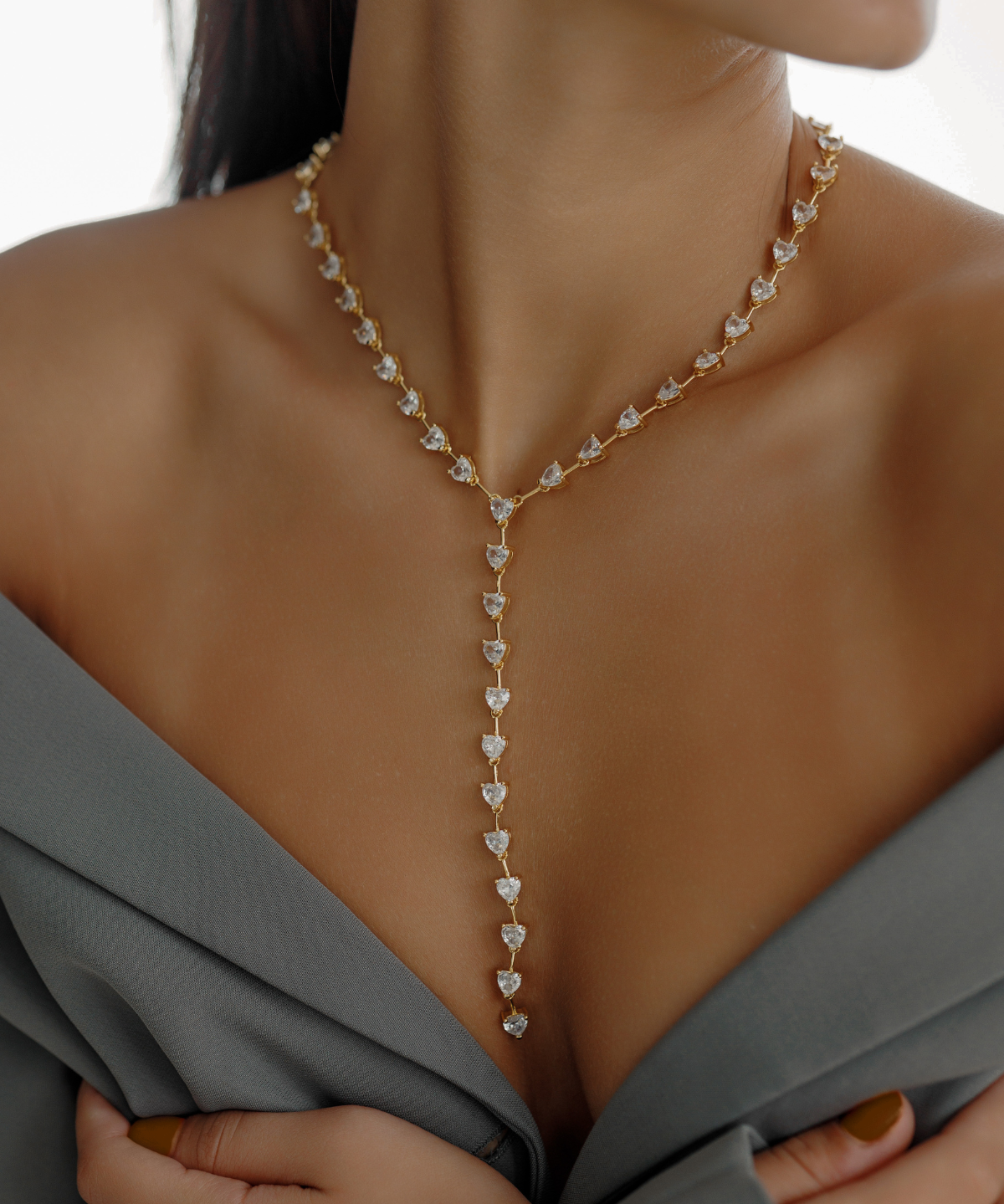 Seraphine Necklace in gold worn to show heart zirconia charm and elegant Y-shaped drop.