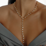 Seraphine Necklace in gold worn to show heart zirconia charm and elegant Y-shaped drop.