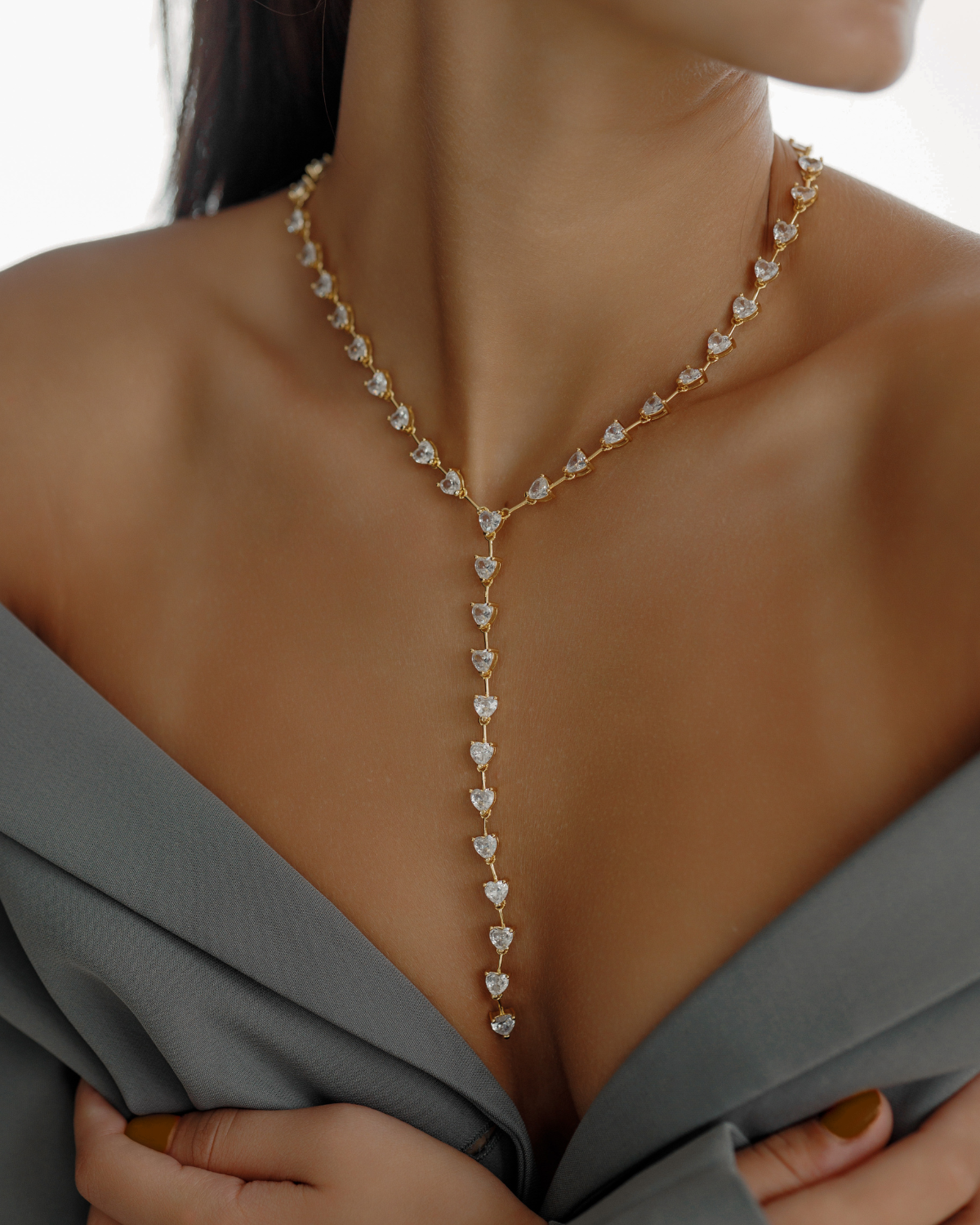 Seraphine Necklace in gold worn to show heart zirconia charm and elegant Y-shaped drop.