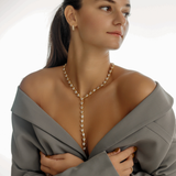 Seraphine Necklace in gold styled for a special occasion, showing the full Y-drop.